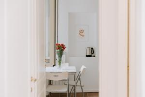 a white dining room with a table and chairs at Casa Vacanze Bottasso 68 in Terracina