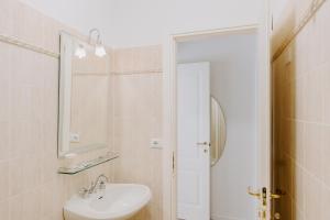 a bathroom with a sink and a mirror at Casa Vacanze Bottasso 68 in Terracina +10 photos