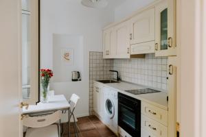 a kitchen with white cabinets and a dishwasher at Casa Vacanze Bottasso 68 in Terracina