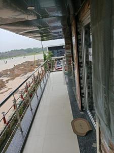 a walkway leading to the beach from a building at countryside view hotel Silchar in Silchar