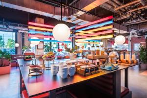 a restaurant with a large counter with food on it at The Social Hub Berlin Alexanderplatz in Berlin