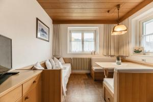 a living room with a couch and a table at Apartments Chalet Zirm in Santa Cristina Gherdëina