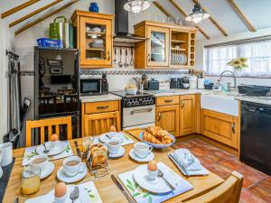 a kitchen with a wooden table with eggs on it at Corner Cottage in Saxmundham