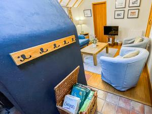 a living room with a large blue object with a living room at Corner Cottage in Saxmundham