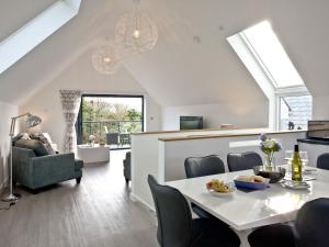 a dining room and living room with a table and chairs at Black Sea Horse in Westward Ho