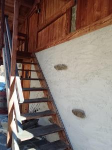 a staircase in a building with a wooden ceiling at B&B Baita Bertolini in Monclassico