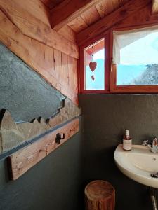 a bathroom with a sink and a window at B&B Baita Bertolini in Monclassico