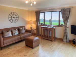 a living room with a couch and a large window at Trelaw - Uk41532 in Cumnock