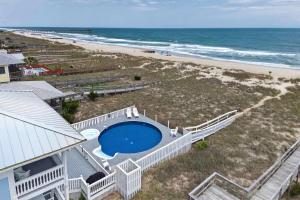 an aerial view of a house and the beach at SEA2SKY Ocean front private pool and spa in Kure Beach