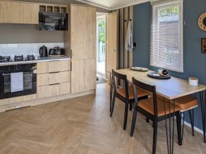a kitchen with a wooden table and some chairs at Solo's in East Heslerton