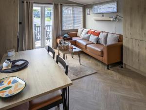 a living room with a couch and a table at Solo's in East Heslerton