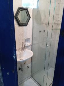 a bathroom with a sink and a glass shower at Casa da tranquilidade in Ouro Preto +23 photos