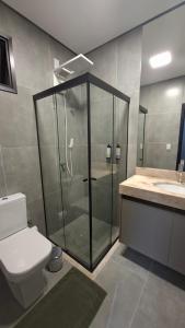a bathroom with a shower and a toilet and a sink at HOTEL JD cravinhos in Cravinhos +33 photos