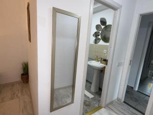 a bathroom with a mirror and a sink at Cazare Vidin in Basarabi