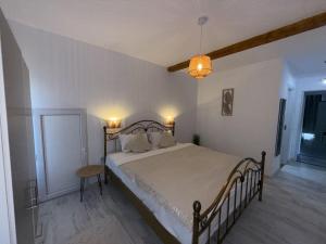 a bedroom with a large bed and a table at Cazare Vidin in Basarabi