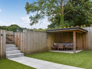 a backyard with a table and a wooden fence at Midge in Newlyn