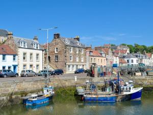 two boats are docked in the water in a city at Dothan Farm Cottage in Cardenden +12 photos