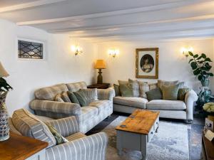 a living room with couches and a table at Rosehill in Truro +22 photos