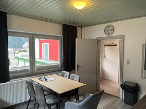 a dining room with a table and chairs and a window at Flying Hirsch in Stall +21 photos