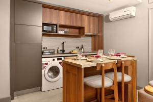 a kitchen with a table and a washing machine at Taksim Premium Residence in Istanbul