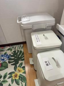 a bathroom with a toilet and a rug at SerenityBlueAmami in Tatsugo +20 photos