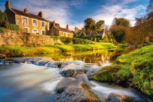 a river in a small town with houses and a creek at Rostrevor Beach House in Rostrevor