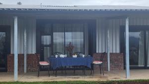 a blue table with chairs on a patio at Kairos Vista in Sedgefield
