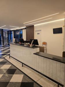 an office lobby with a reception counter with a desk at Plaza Inn Small Town Flat in São Paulo +42 photos