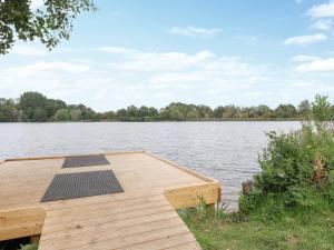 a dock on a lake with a solar panel on it at Riverview in Somerford Keynes