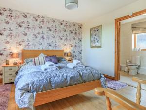 a bedroom with a bed with two towels on it at The Cartlinhay - Uk35756 in Bideford +2 photos