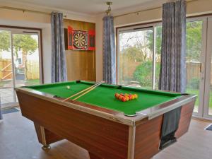 a pool table with balls on it in a room at Ysgubor Wen in Burry Port