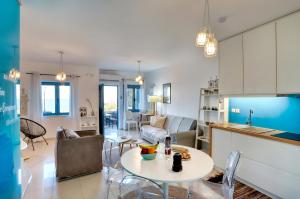a living room with a couch and a table at Seafront Villa Moments, by Estia in Mochlos