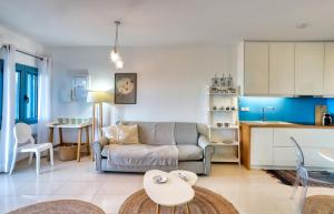 a living room with a couch and a kitchen at Seafront Villa Moments, by Estia in Mochlos