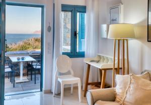 a living room with a view of the ocean at Seafront Villa Moments, by Estia in Mochlos