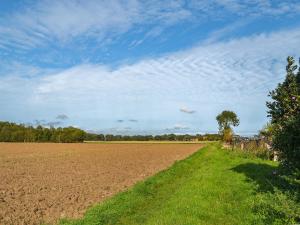 a field with a blue sky and green grass at Atmospheric in Patrington