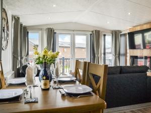 a dining room with a table and a couch at Atmospheric in Patrington +13 photos