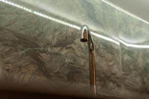a glass shower with a metal shower head at Martin Villa 2 in Gjirokastër +30 photos