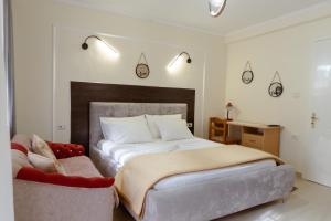 a bedroom with a large bed and a chair at Martin Villa 2 in Gjirokastër