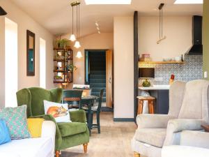 a living room with green chairs and a table at The Watertower in Marlborough