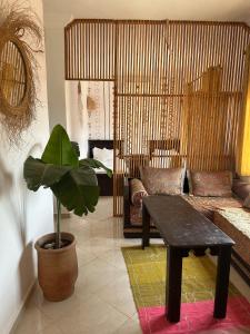 a living room with a couch and a table at Surf and Tribe in Tamraght Ouzdar