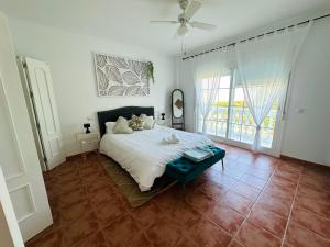 a bedroom with a bed and a large window at Villa El Dorado in Estepona +37 photos