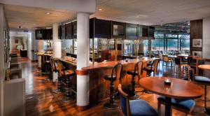 a bar with tables and chairs in a restaurant at Braunschweig Seminarius Hotel by Belvilla in Braunschweig