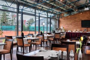 a restaurant with tables and chairs and a large window at Braunschweig Seminarius Hotel by Belvilla in Braunschweig