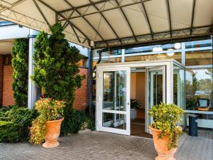 an open door of a building with potted plants at Braunschweig Seminarius Hotel by Belvilla in Braunschweig
