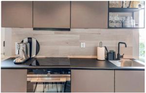 a kitchen with a sink and a counter top at Seawiew in Helsingborg