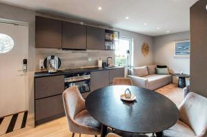 a kitchen and living room with a table and chairs at Seawiew in Helsingborg