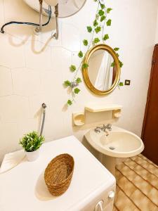 a bathroom with a sink and a mirror on the wall at Terrazza sul Borgo in Camerota