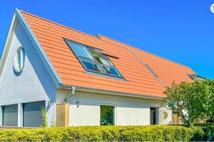a house with an orange roof with a window at Seawiew in Helsingborg