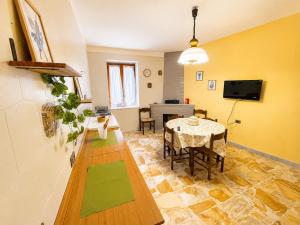 a living room with a table and a television at Terrazza sul Borgo in Camerota +29 photos