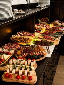 a buffet line with many different types of food at Pensiunea Merişor in Răchiţele